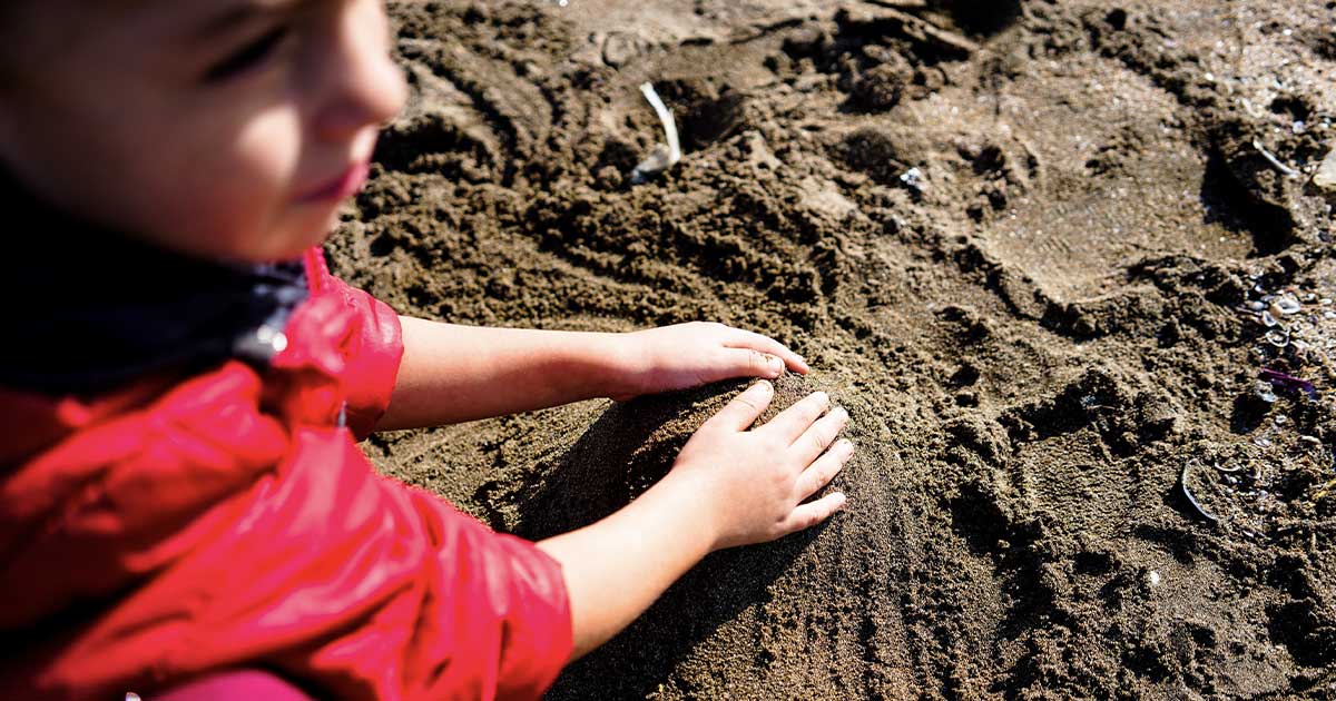boy plays in dirt